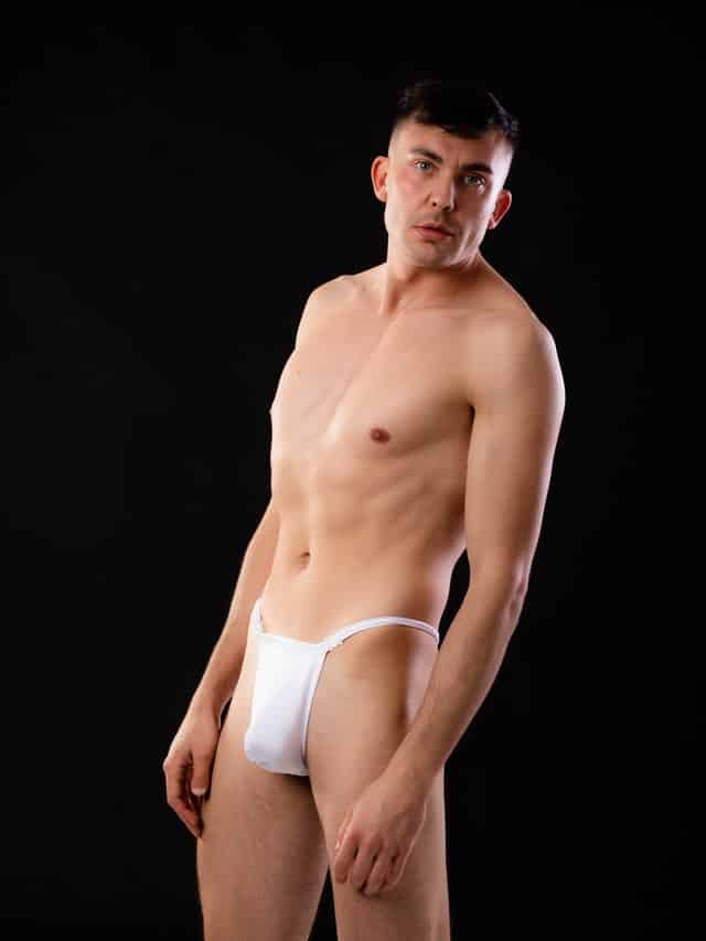 Man wearing white g string underwear posing